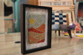 Moroccan rug, framed wool wall art, sunset desert tapestry, hand-knotted Moroccan textile, boho decor, wool landscape artwork, Berber weaving, shadow box rug, handmade Moroccan rug art, earth tone wall hanging, artisanal rug design, knot by knot rug, 25x31cm framed rug, woven Moroccan wall decor
