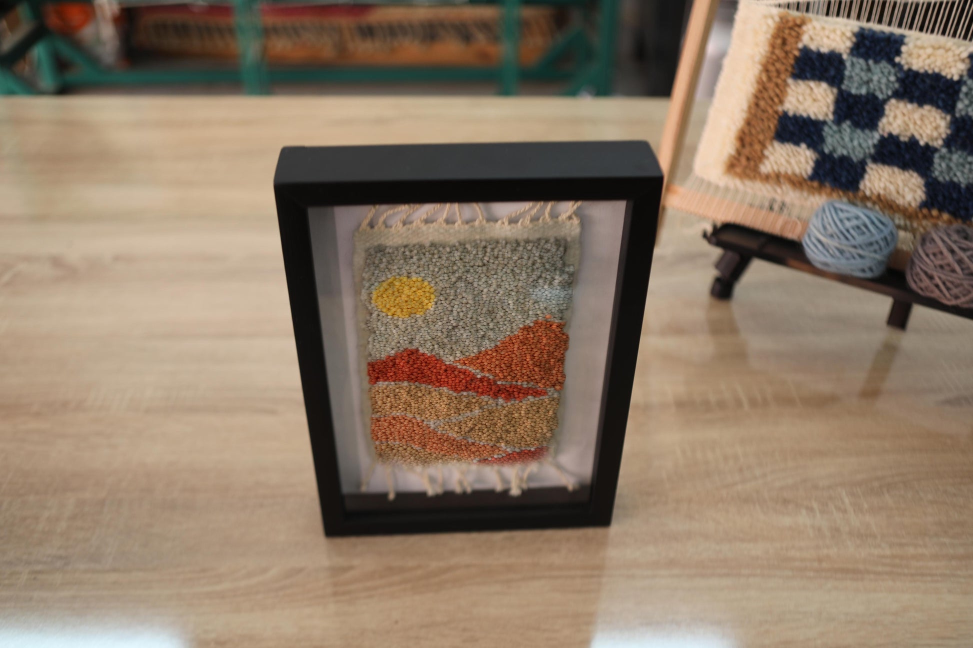 Moroccan rug, framed wool wall art, sunset desert tapestry, hand-knotted Moroccan textile, boho decor, wool landscape artwork, Berber weaving, shadow box rug, handmade Moroccan rug art, earth tone wall hanging, artisanal rug design, knot by knot rug, 25x31cm framed rug, woven Moroccan wall decor
