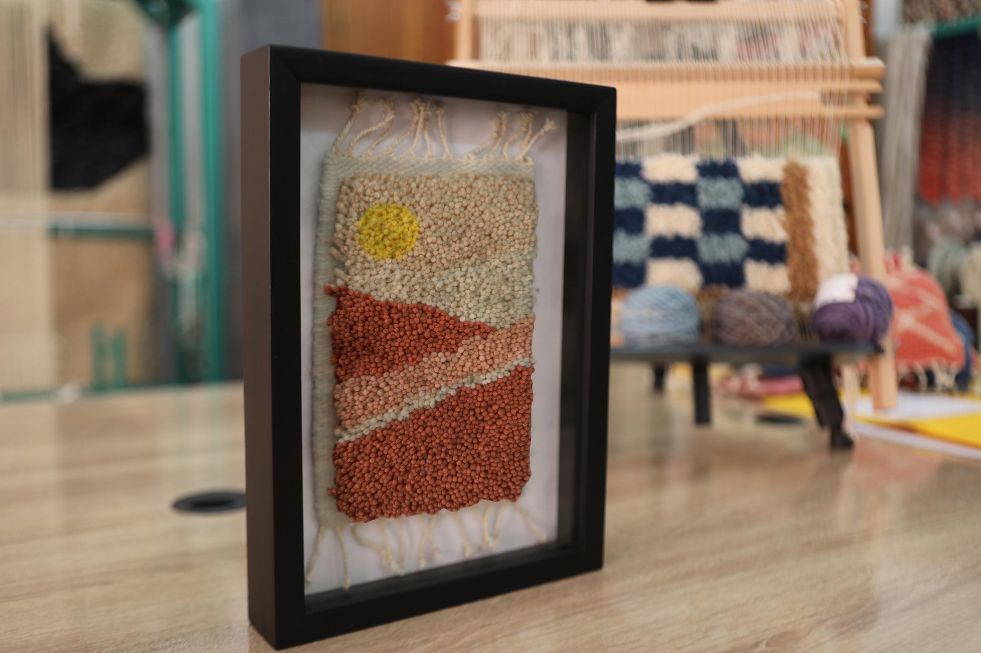 Moroccan rug, sunrise desert wall art, framed wool tapestry, hand-knotted wool wall hanging, Berber weaving, artisanal Moroccan rug, handmade rug art, knot by knot Moroccan textile, 25x31cm framed rug, earth tone wall decor, boho desert decor, Moroccan craftsmanship, wool fiber art, rustic framed rug
