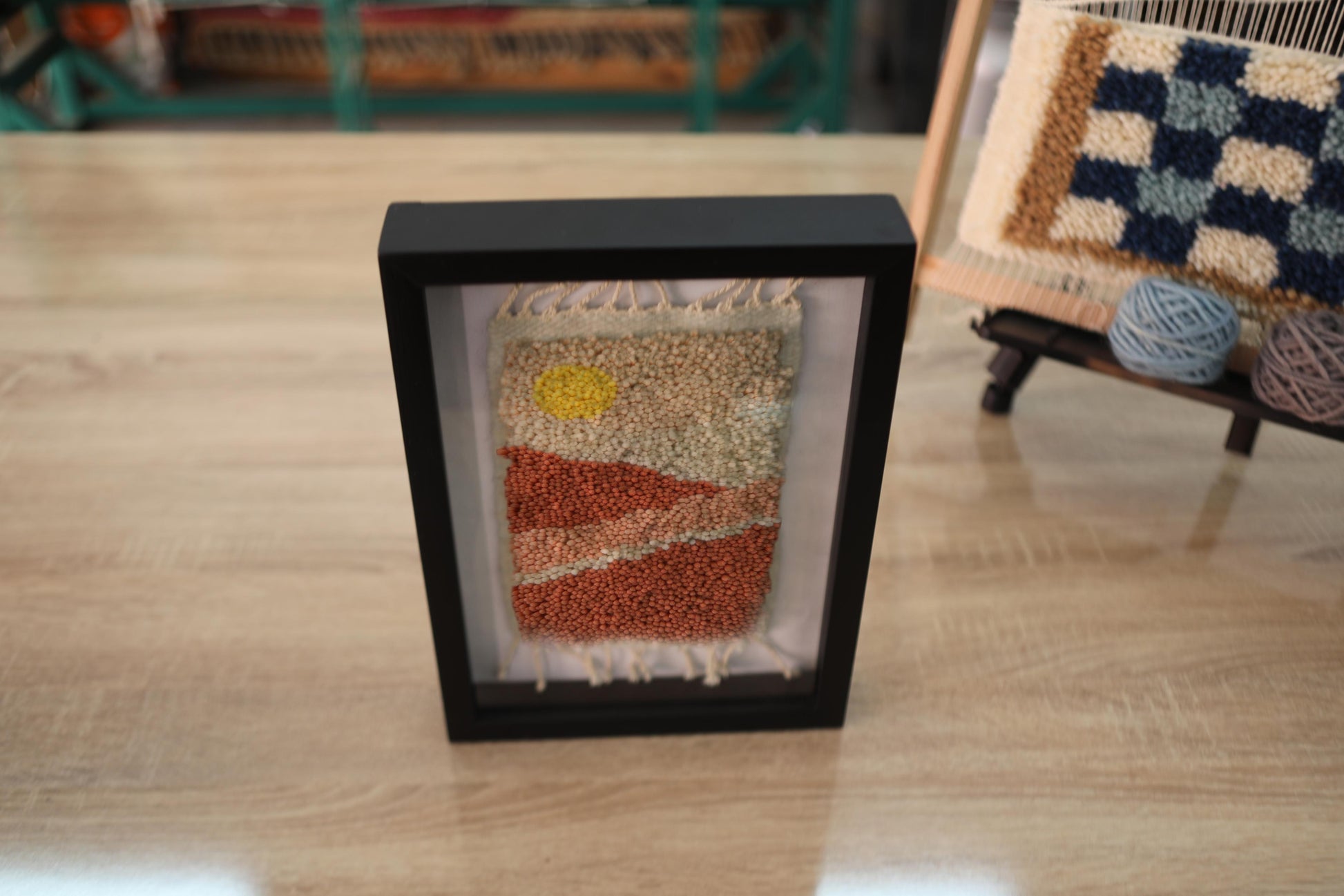 Moroccan rug, sunrise desert wall art, framed wool tapestry, hand-knotted wool wall hanging, Berber weaving, artisanal Moroccan rug, handmade rug art, knot by knot Moroccan textile, 25x31cm framed rug, earth tone wall decor, boho desert decor, Moroccan craftsmanship, wool fiber art, rustic framed rug
