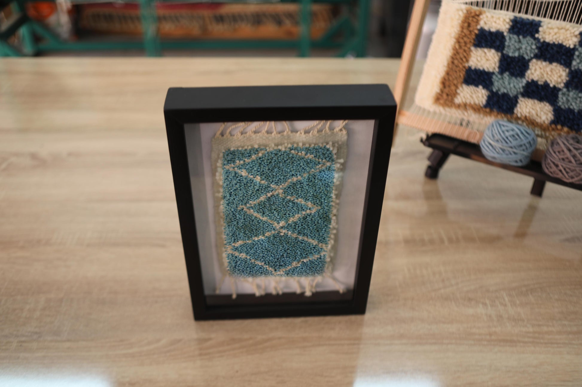 central diamond moroccan rug, framed wool moroccan rug art, moroccan rug wall hanging, mini wool moroccan carpet, hand-knotted small moroccan rug, bohemian framed textile art, artisan moroccan rug decor, 25x31 cm rug artwork, knot by knot rug wall decor, moroccan wall tapestry blue
