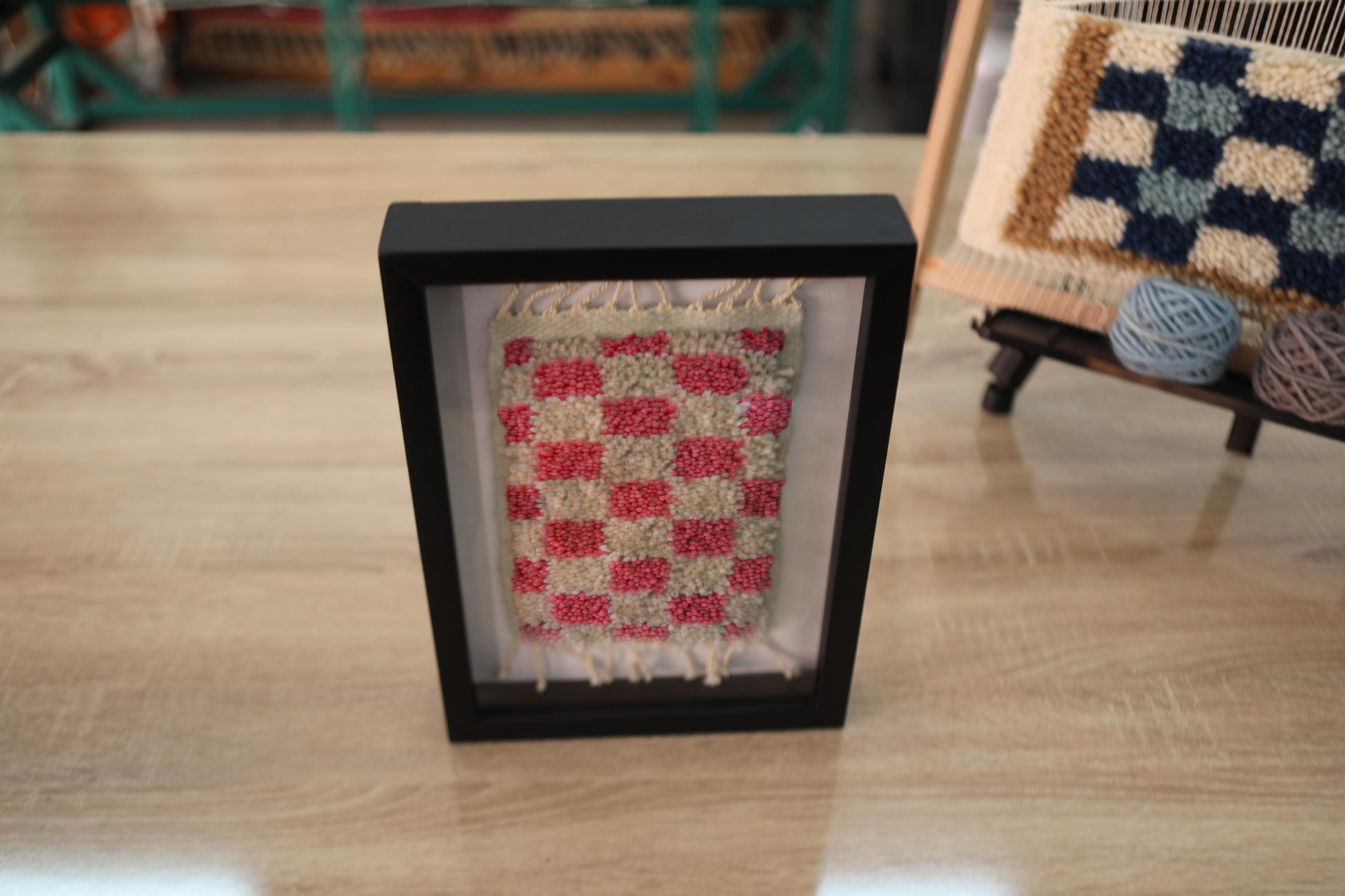 checkerboard moroccan rug, red and cream mini rug, hand-knotted wool rug, mini moroccan textile art, framed moroccan wall decor, wool checker pattern, artisan rug morocco, moroccan rug 25x31 cm, wool wall hanging, boho moroccan decor

