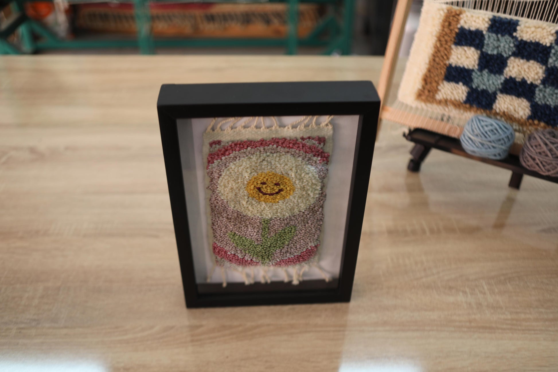 cream smiling flower rug, moroccan rug wall art, hand-knotted mini wool tapestry, framed flower textile, bohemian wool wall decor, yellow floral face rug, knot by knot moroccan rug, wool flower wall hanging, 25x31 cm framed rug art, happy flower wall textile
