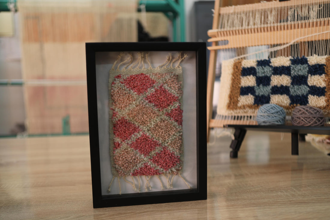 diamond pattern moroccan rug, framed mini moroccan textile, red beige wall art, hand-knotted moroccan decor, artisan rug weaving, 25x31 cm wool rug, geometric moroccan rug, boho textile frame, knot by knot moroccan craft, red and neutral rug design
