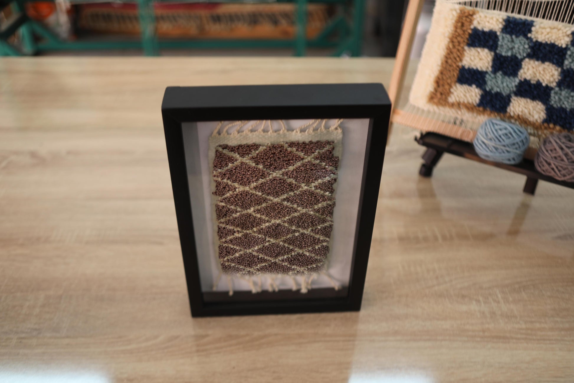 moroccan rug, beige brown wall art, hand knotted wool, mini rug decor, lozenge pattern moroccan textile, knot by knot framed rug, natural wool artwork, minimalist tribal rug, neutral moroccan rug, framed wool decor
