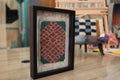 moroccan rug, diamond pattern rug, framed wool rug, hand knotted moroccan tapestry, red and green rug wall art, artisan moroccan weaving, knot by knot wall decor, small moroccan rug art, geometric wool textile
