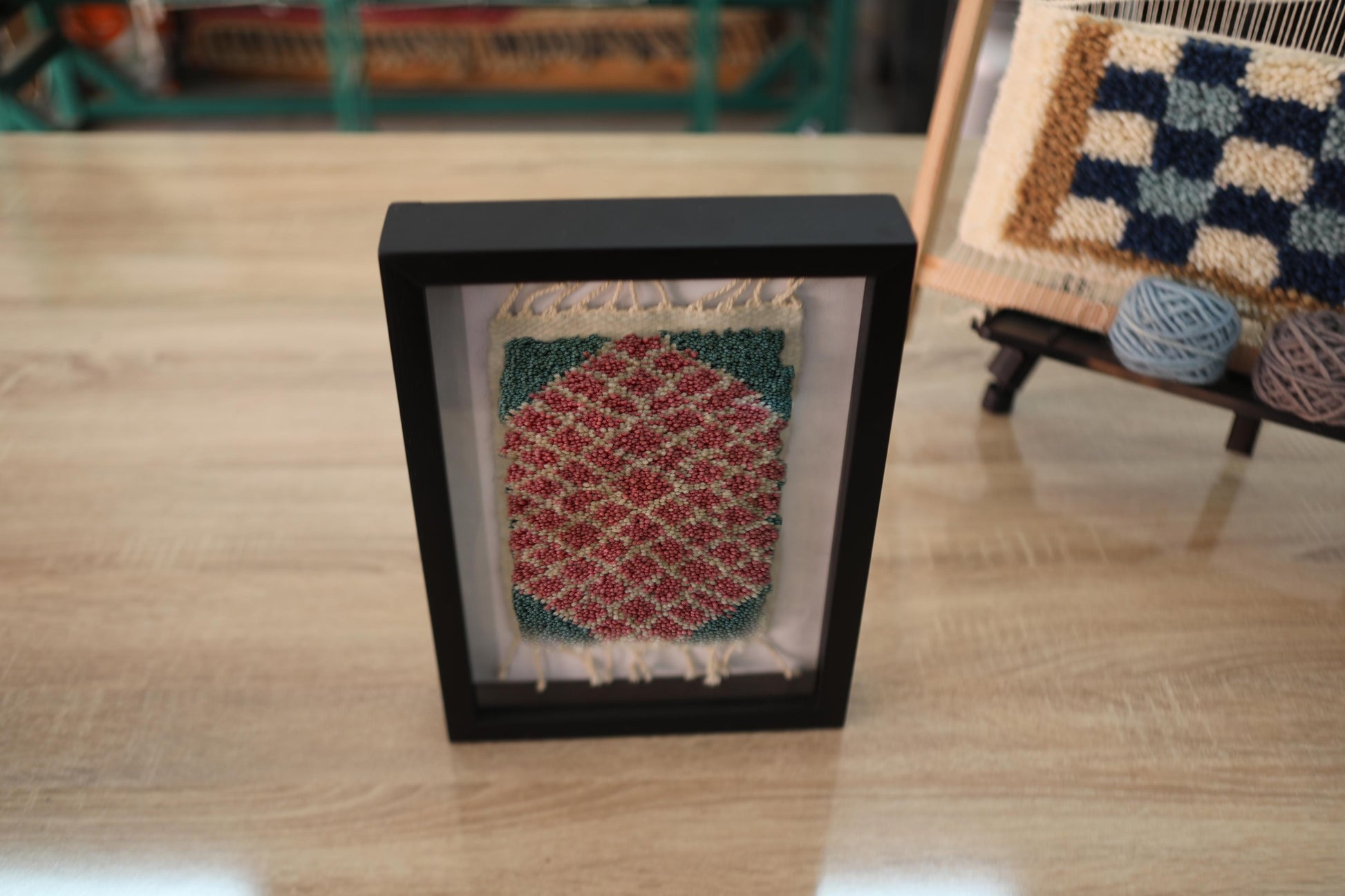 moroccan rug, diamond pattern rug, framed wool rug, hand knotted moroccan tapestry, red and green rug wall art, artisan moroccan weaving, knot by knot wall decor, small moroccan rug art, geometric wool textile
