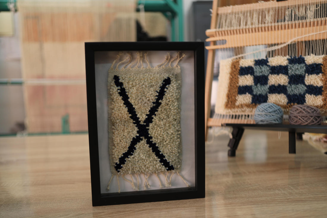 moroccan rug, framed rug art, diagonal x motif, minimalist moroccan wall decor, hand-knotted wool rug, tribal art, wool wall hanging, berber handmade textile, black x rug, moroccan framed artwork
