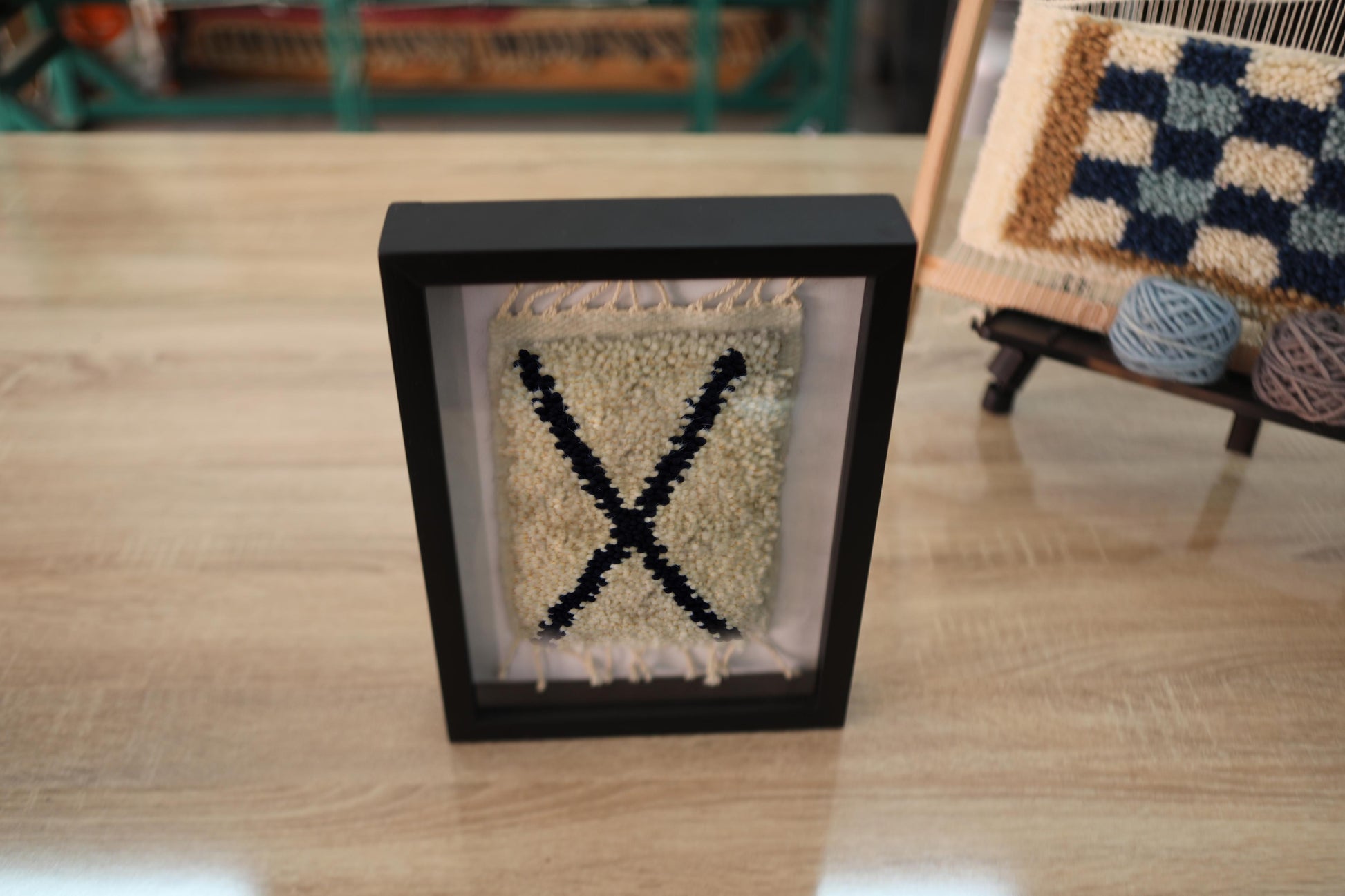 moroccan rug, framed rug art, diagonal x motif, minimalist moroccan wall decor, hand-knotted wool rug, tribal art, wool wall hanging, berber handmade textile, black x rug, moroccan framed artwork
