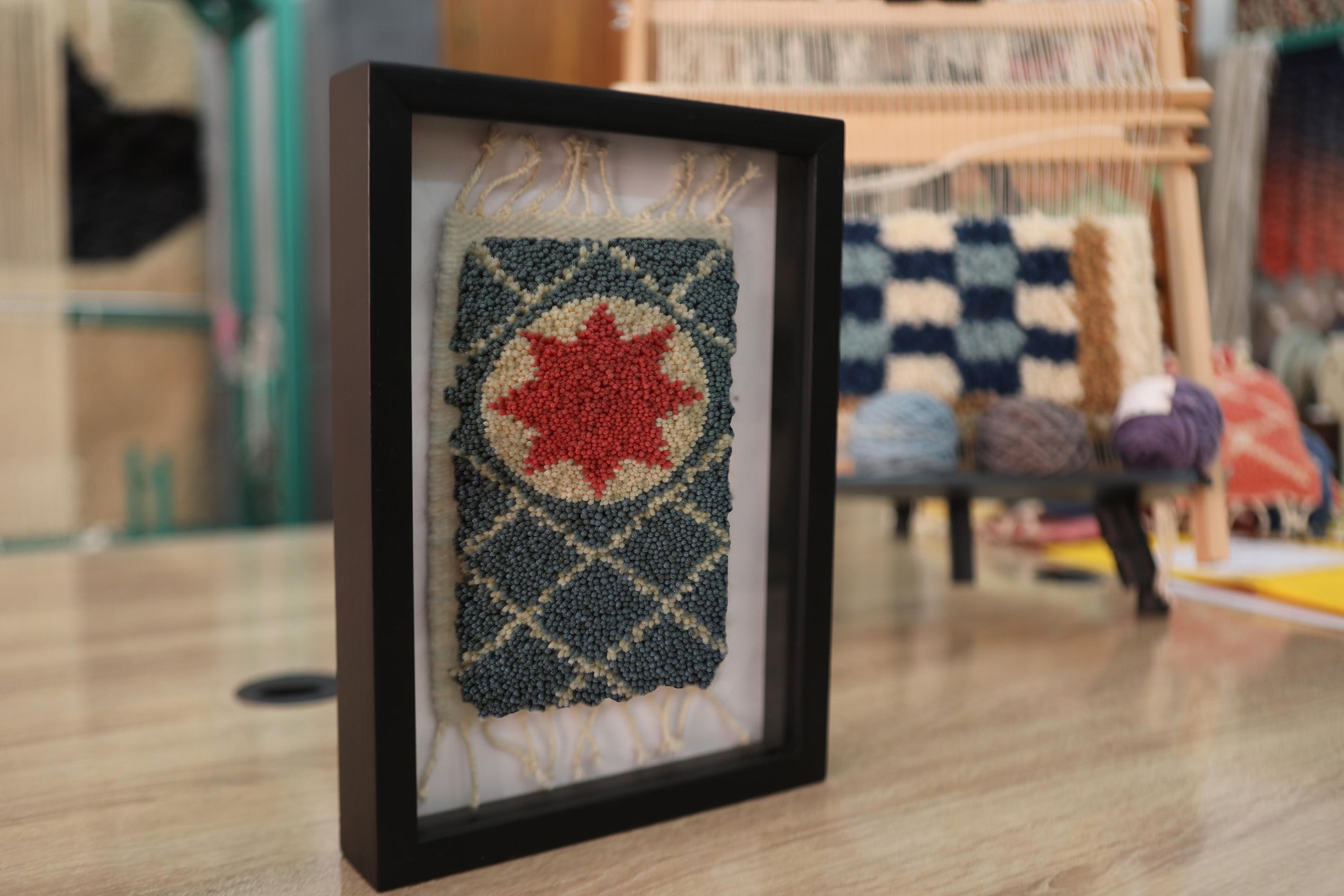moroccan rug, framed rug art, red star medallion, hand knotted wool rug, wool wall hanging, geometric moroccan textile, moroccan miniature rug, artisan rug design, bohemian decor, traditional moroccan craft
