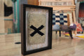 moroccan rug, framed rug wall art, black x motif rug, minimalist moroccan decor, hand-knotted wool rug, knot by knot rug weaving, tribal wall hanging, framed textile art, moroccan x symbol rug, berber wool artwork
