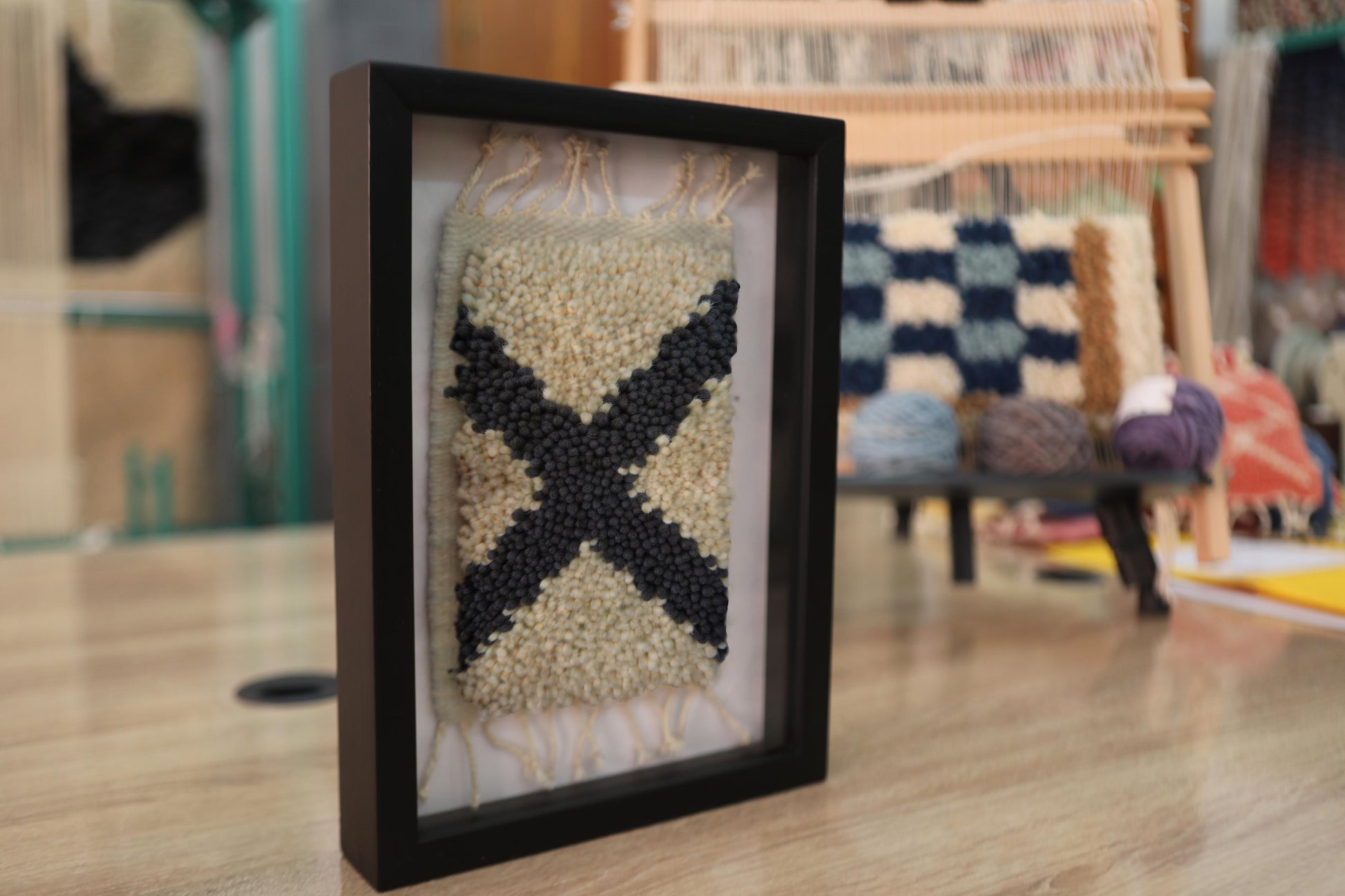 moroccan rug, framed wall art, black x motif, wool textile art, boho wall decor, hand-knotted mini rug, berber weaving, tribal moroccan design, wool framed tapestry, handmade rug artwork
