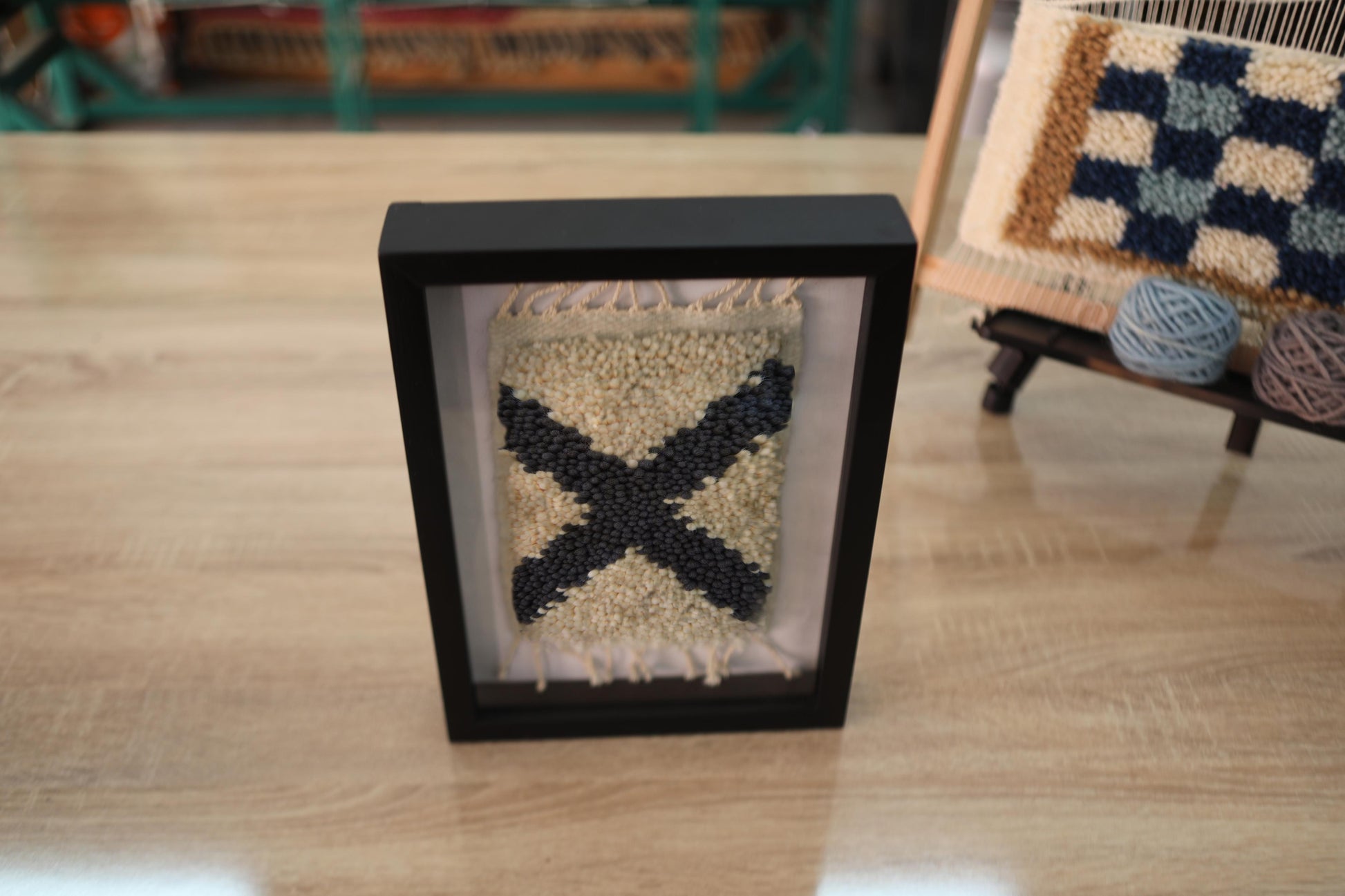 moroccan rug, framed wall art, black x motif, wool textile art, boho wall decor, hand-knotted mini rug, berber weaving, tribal moroccan design, wool framed tapestry, handmade rug artwork

