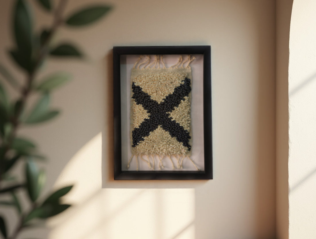 Add character to your wall with this 25x31 cm hand-knotted Moroccan rug featuring a bold black X motif. Framed and ready to hang, each piece is woven knot by knot by Moroccan artisans.
