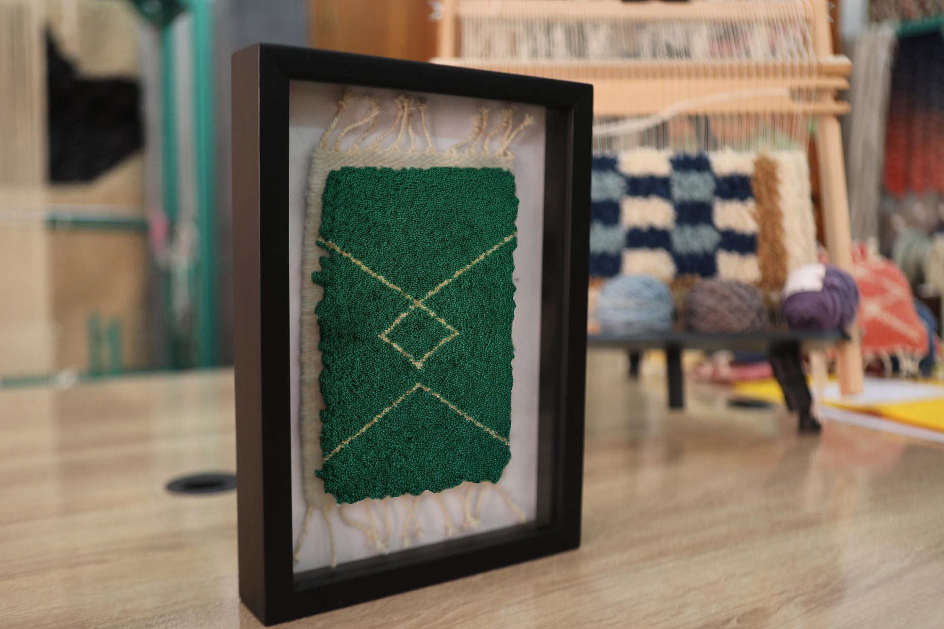 moroccan rug, green wool rug, framed mini rug, hand-knotted rug, diamond motif, artisan wall art, knot by knot weaving, small moroccan decor, wool wall hanging, traditional moroccan rug, framed rug wall piece
