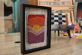 moroccan rug, hand-knotted wall art, sunburst horizon rug, framed boho decor, artisan wool wall hanging, knot by knot handmade, orange red yellow textile art, framed mini rug, 25x31 cm rug art
