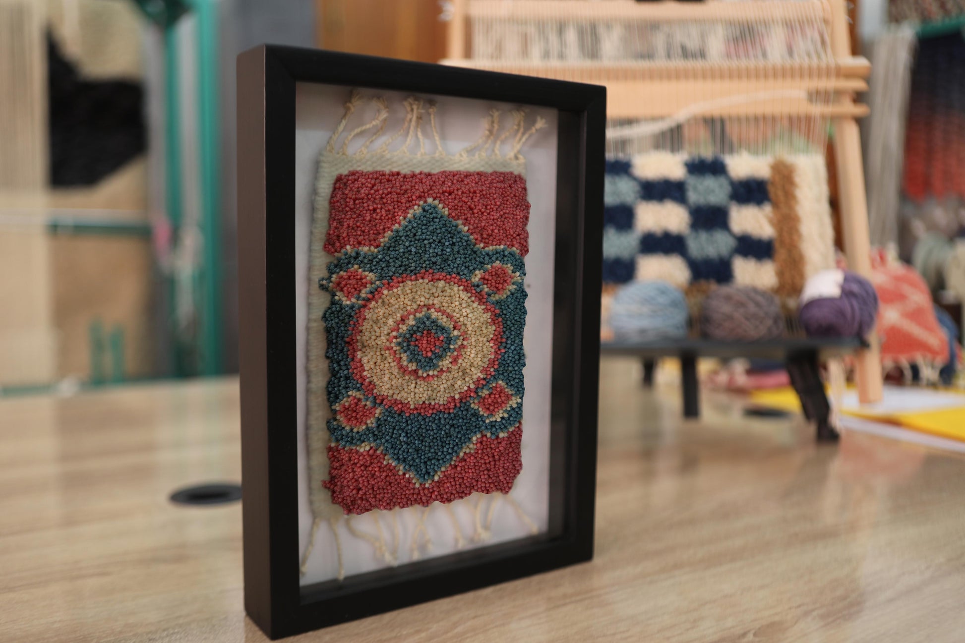 moroccan rug, medallion rug, circular rug motif, framed wool tapestry, hand knotted rug wall art, artisan moroccan weaving, red blue beige rug, mini moroccan textile, boho home decor, knot by knot weaving
