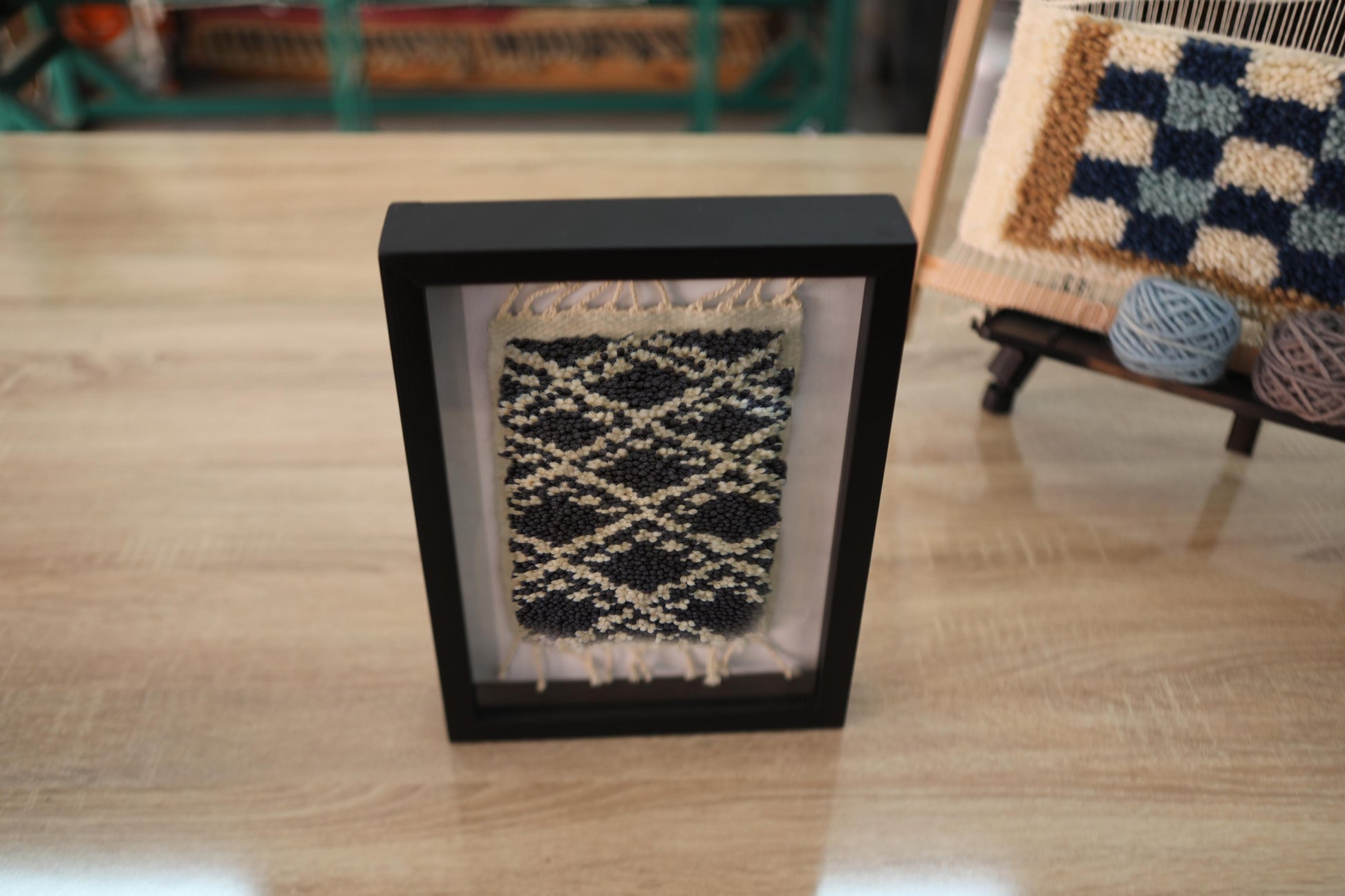 moroccan rug, mini rug wall art, hand-knotted wool, black and beige rug, diamond lattice pattern, artisan textile, knot by knot rug, wool wall hanging, bohemian decor, framed moroccan rug, tribal rug wall piece
