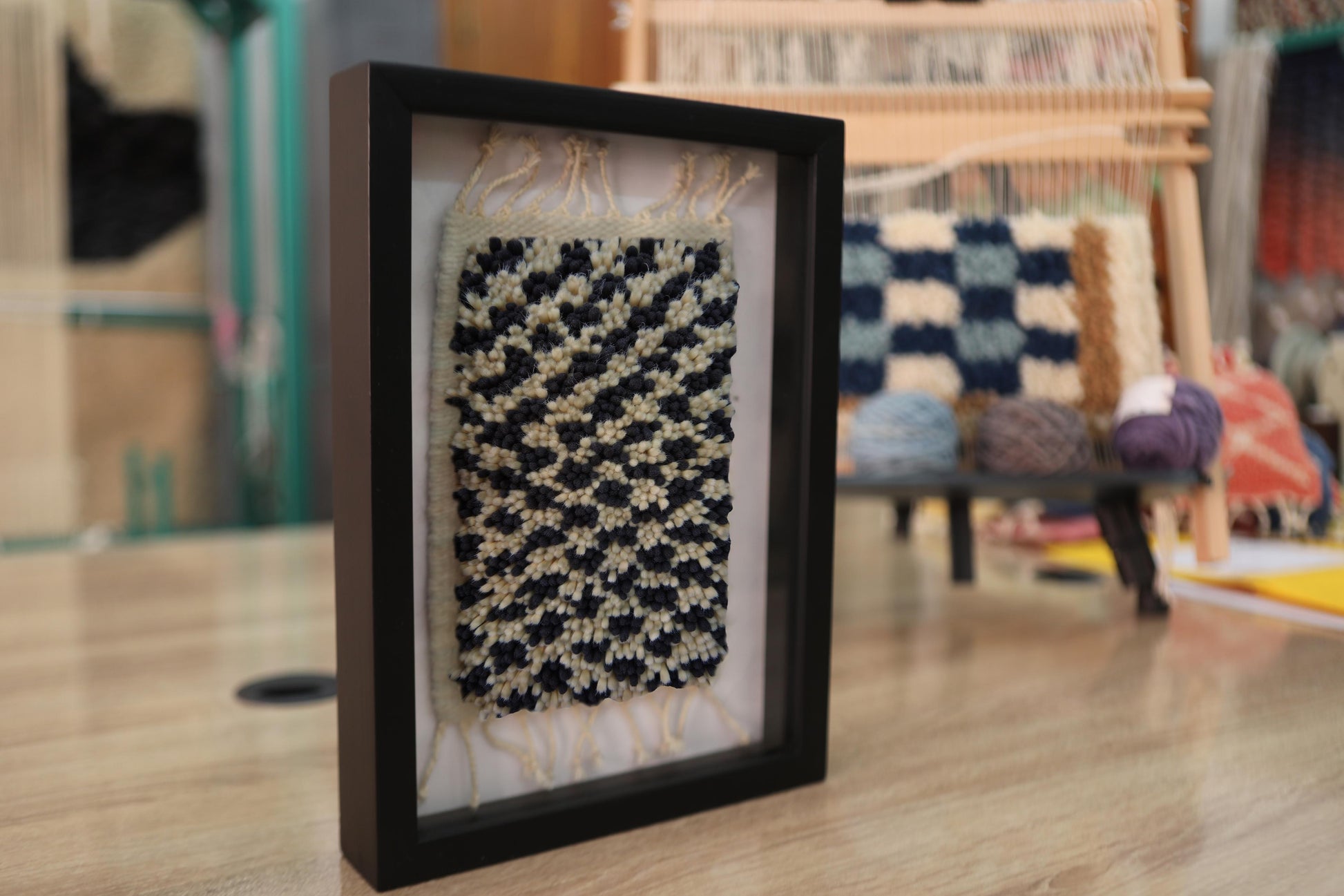 moroccan rug, ripple pattern wall art, hand knotted wool, black ivory mini rug, wool wall hanging, framed textile decor, artisanal moroccan weaving, boho rug art, knot by knot rug, 25x31 cm moroccan piece
