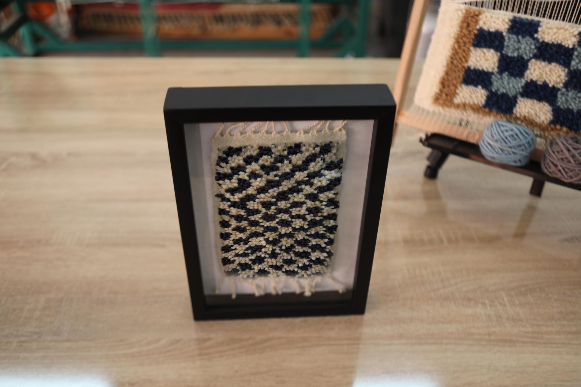 moroccan rug, ripple pattern wall art, hand knotted wool, black ivory mini rug, wool wall hanging, framed textile decor, artisanal moroccan weaving, boho rug art, knot by knot rug, 25x31 cm moroccan piece
