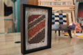 moroccan rug, striped rug wall art, hand-knotted textile, framed moroccan rug, earthy colors decor, boho wool wall hanging, diagonal pattern, knot by knot weaving, small rug art, moroccan wool decor
