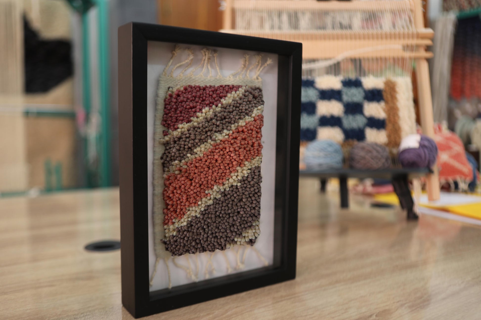 moroccan rug, striped rug wall art, hand-knotted textile, framed moroccan rug, earthy colors decor, boho wool wall hanging, diagonal pattern, knot by knot weaving, small rug art, moroccan wool decor

