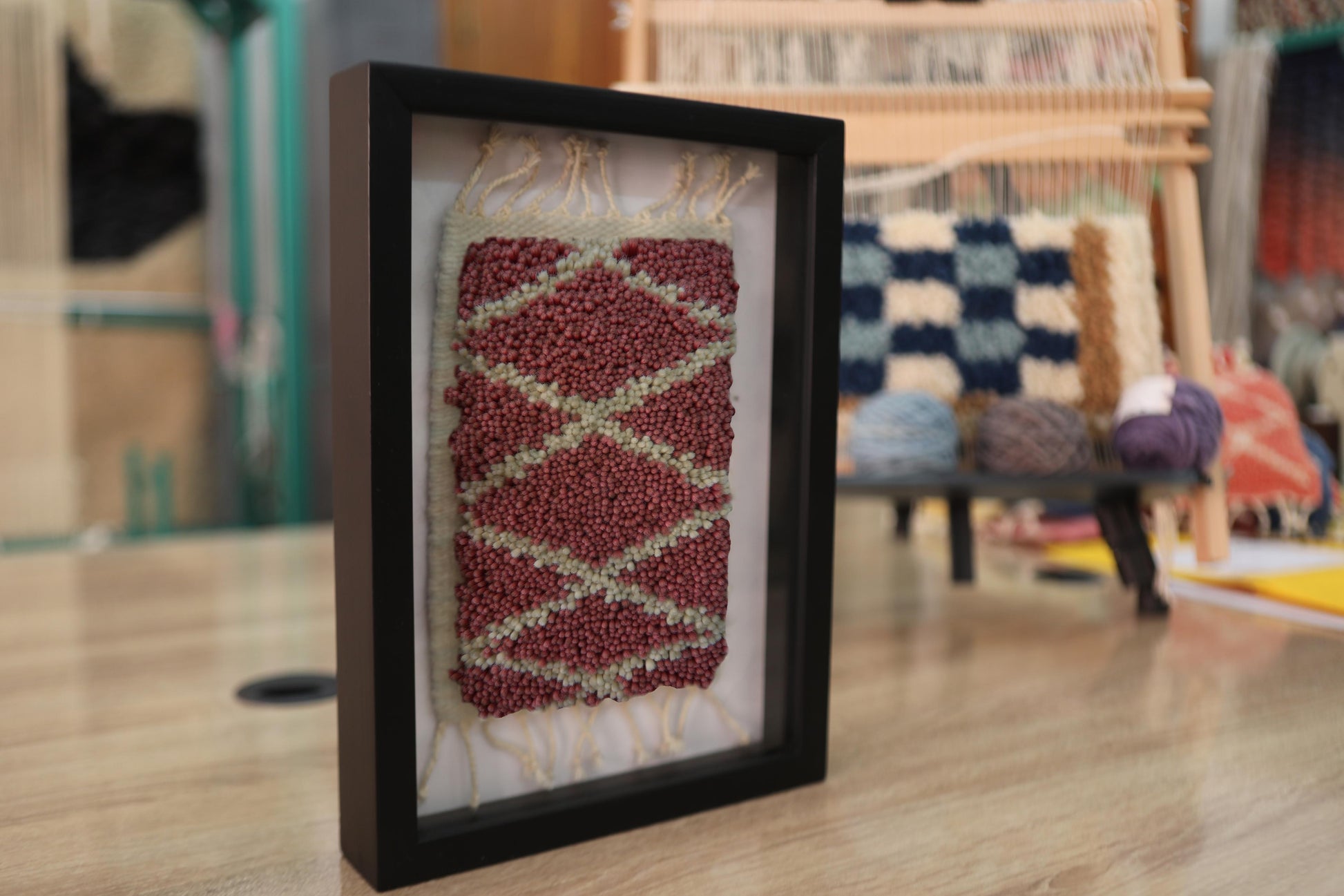 moroccan rug, zigzag wool wall art, hand-knotted mini rug, red and ivory rug, tribal textile, berber rug design, framed moroccan decor, bohemian fiber art, artisan weaving, knot by knot wool rug
