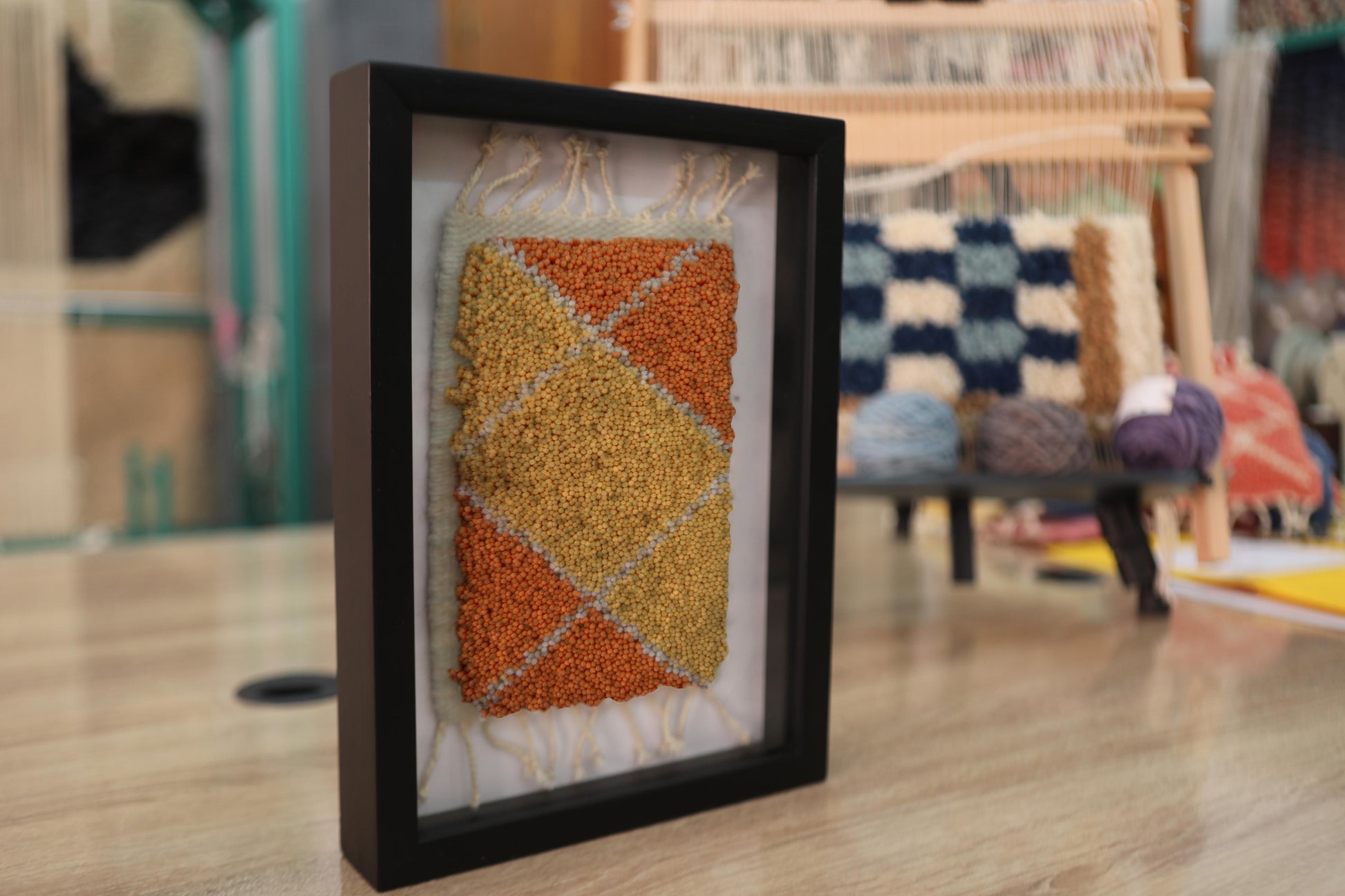 moroccan rug diamond pattern, geometric wool wall art, hand knotted mini rug, framed moroccan textile, orange and yellow moroccan art, boho rug wall hanging, artisan moroccan wool tapestry, knot by knot moroccan rug, earthy home decor, 25x31 cm framed rug
