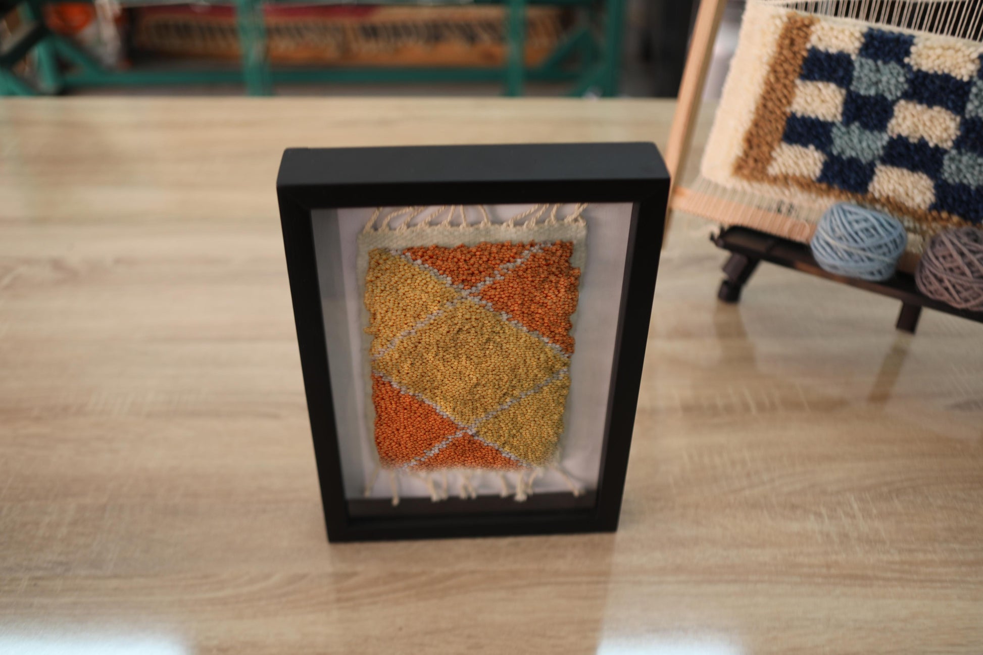 moroccan rug diamond pattern, geometric wool wall art, hand knotted mini rug, framed moroccan textile, orange and yellow moroccan art, boho rug wall hanging, artisan moroccan wool tapestry, knot by knot moroccan rug, earthy home decor, 25x31 cm framed rug
