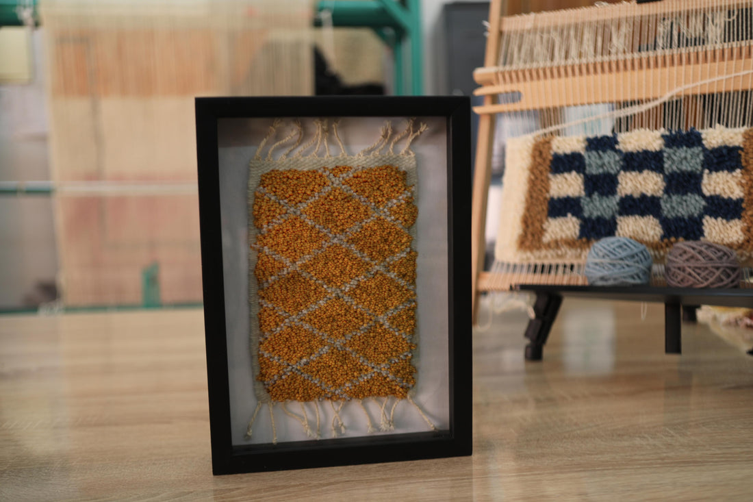 moroccan rug diamond pattern, ochre wool mini rug, framed rug wall art, hand-knotted moroccan textile, small wool rug decor, knot by knot moroccan rug, boho wall tapestry, geometric moroccan artwork, 25x31 cm framed rug, artisan mini moroccan rug
