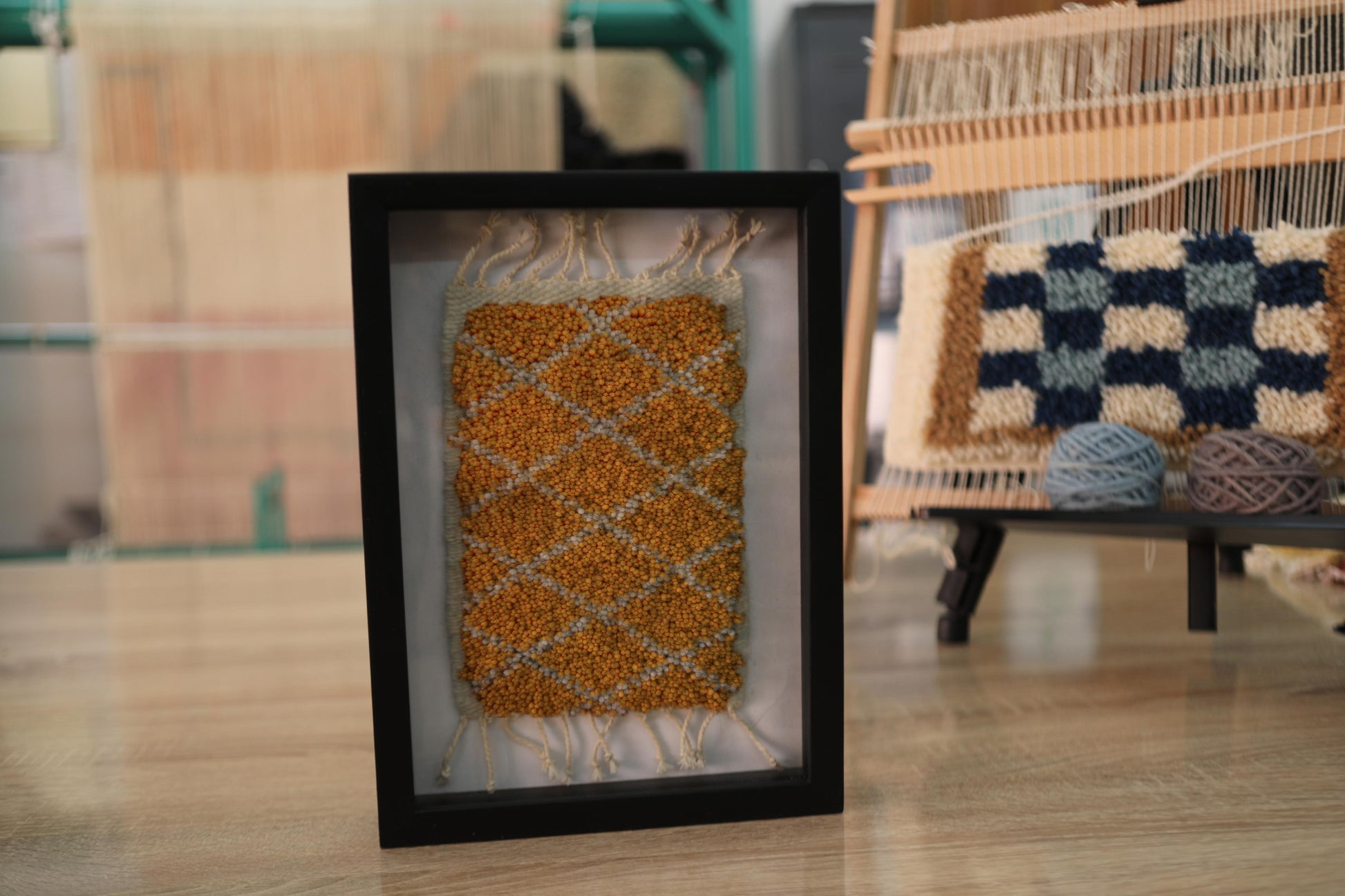 moroccan rug diamond pattern, ochre wool mini rug, framed rug wall art, hand-knotted moroccan textile, small wool rug decor, knot by knot moroccan rug, boho wall tapestry, geometric moroccan artwork, 25x31 cm framed rug, artisan mini moroccan rug
