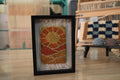 moroccan rug sun design, sunrise rug wall art, desert landscape textile, framed wool moroccan mini rug, boho sun pattern decor, handmade moroccan wool art, knot by knot rug, artisan moroccan wall hanging, earthy wool tapestry, 25x31 cm moroccan framed rug
