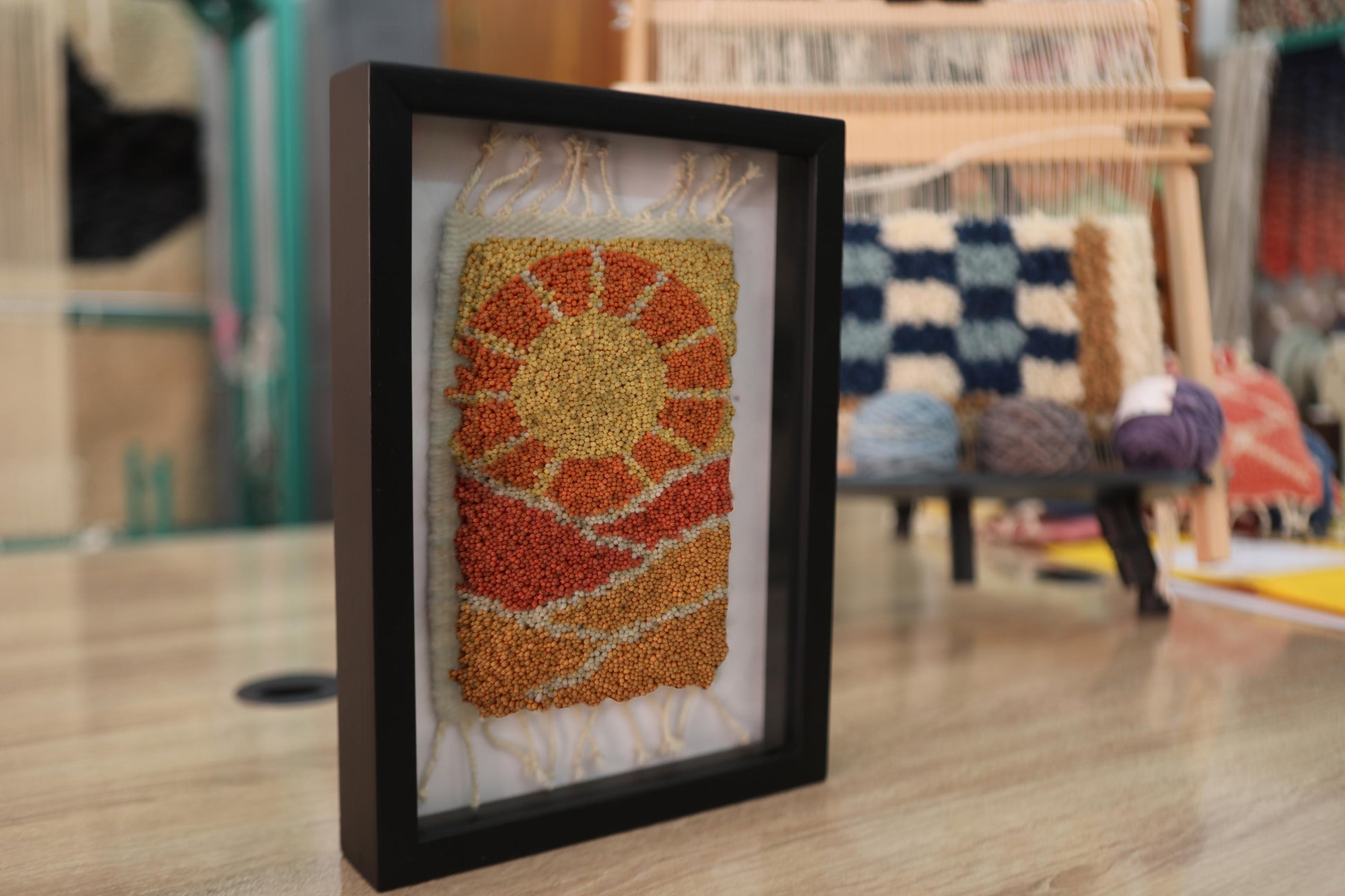 moroccan rug sun design, sunrise rug wall art, desert landscape textile, framed wool moroccan mini rug, boho sun pattern decor, handmade moroccan wool art, knot by knot rug, artisan moroccan wall hanging, earthy wool tapestry, 25x31 cm moroccan framed rug
