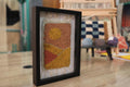 moroccan rug wall art, abstract sunset rug, hand knotted textile art, boho framed moroccan rug, orange yellow wall decor, knot by knot mini rug, artisan wool wall art, geometric moroccan design, framed wool tapestry, 25x31 cm handmade moroccan rug
