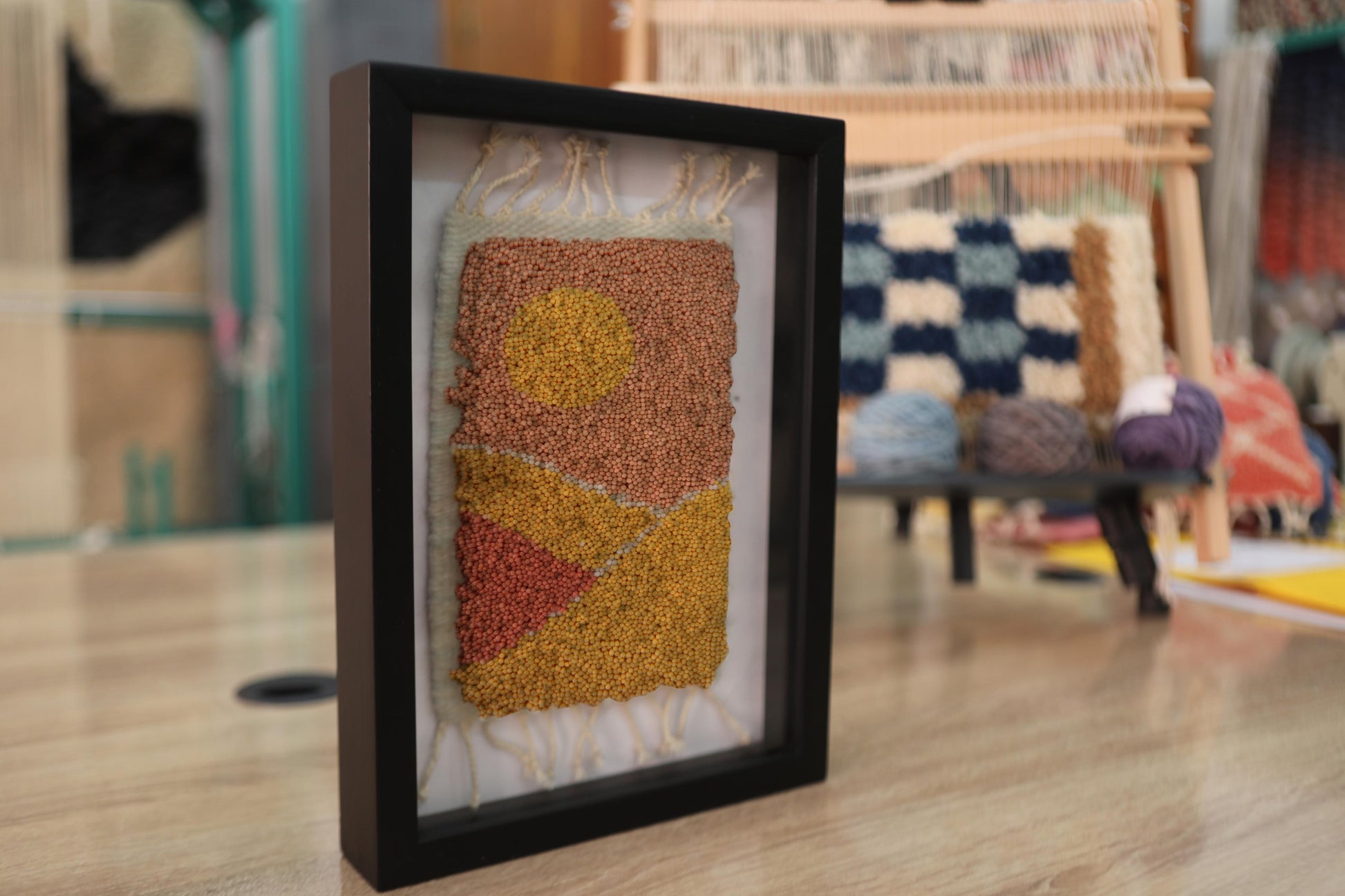moroccan rug wall art, abstract sunset rug, hand knotted textile art, boho framed moroccan rug, orange yellow wall decor, knot by knot mini rug, artisan wool wall art, geometric moroccan design, framed wool tapestry, 25x31 cm handmade moroccan rug
