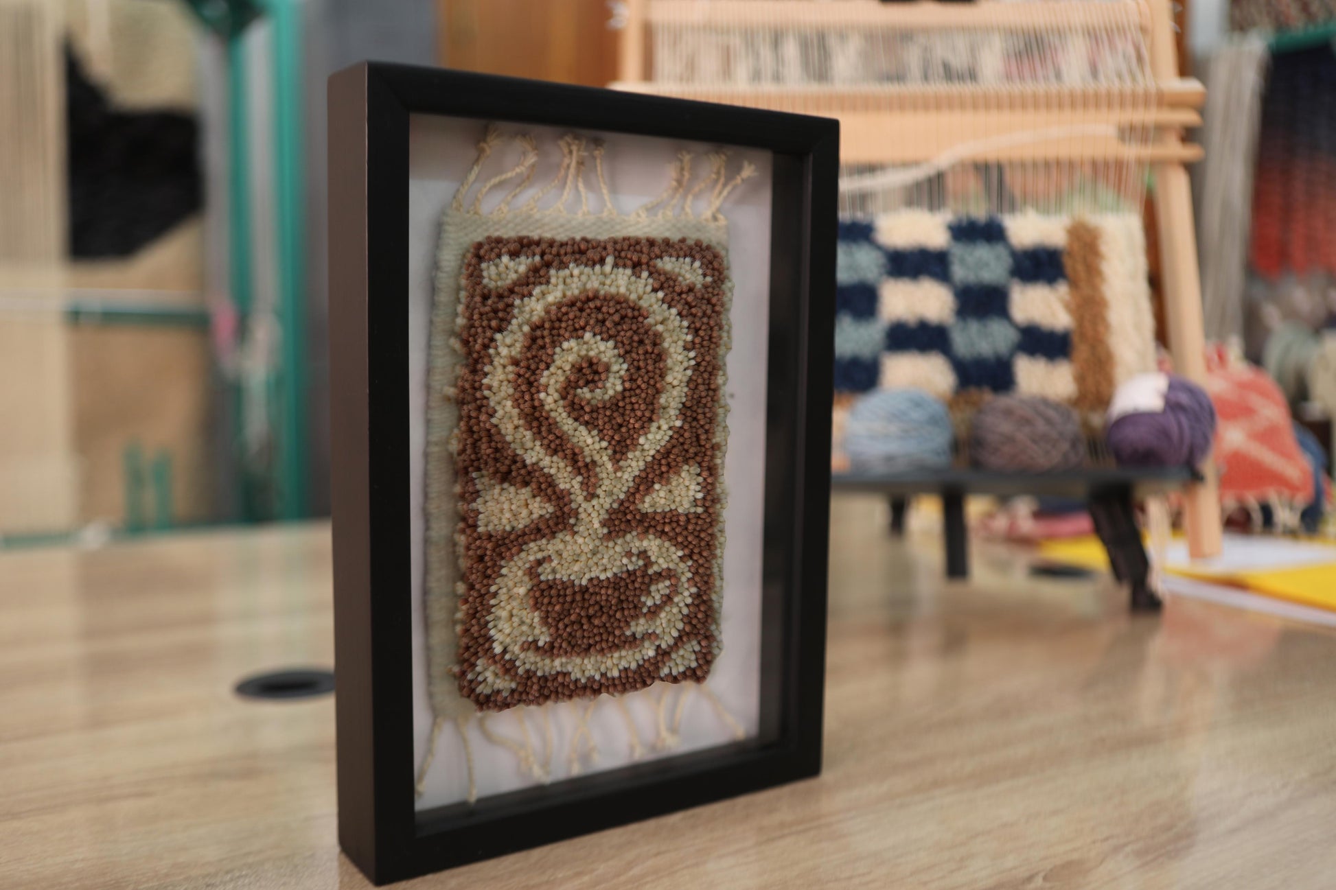 moroccan rug wall art, calligraphy swirl decor, abstract wool textile, hand knotted wall hanging, artisan rug art, framed moroccan design, wool wall tapestry, knot by knot rug, 25x31 cm
