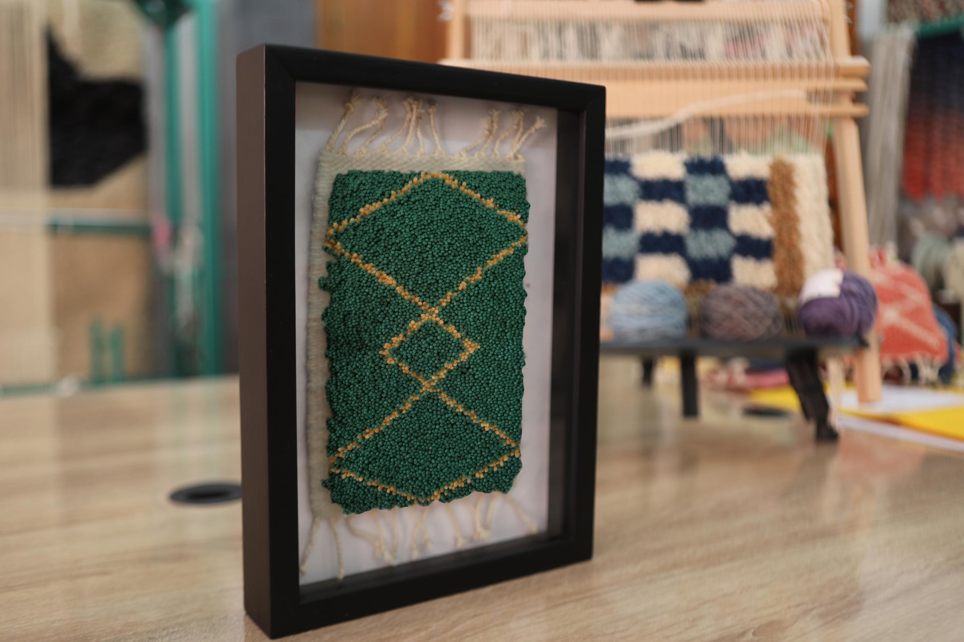 moroccan rug wall art, diamond motif rug, green and gold wool textile, hand-knotted moroccan decor, knot by knot framed rug, artisan wall hanging, boho moroccan art, 25x31 cm wool rug, moroccan mini wall tapestry, framed ethnic rug decor
