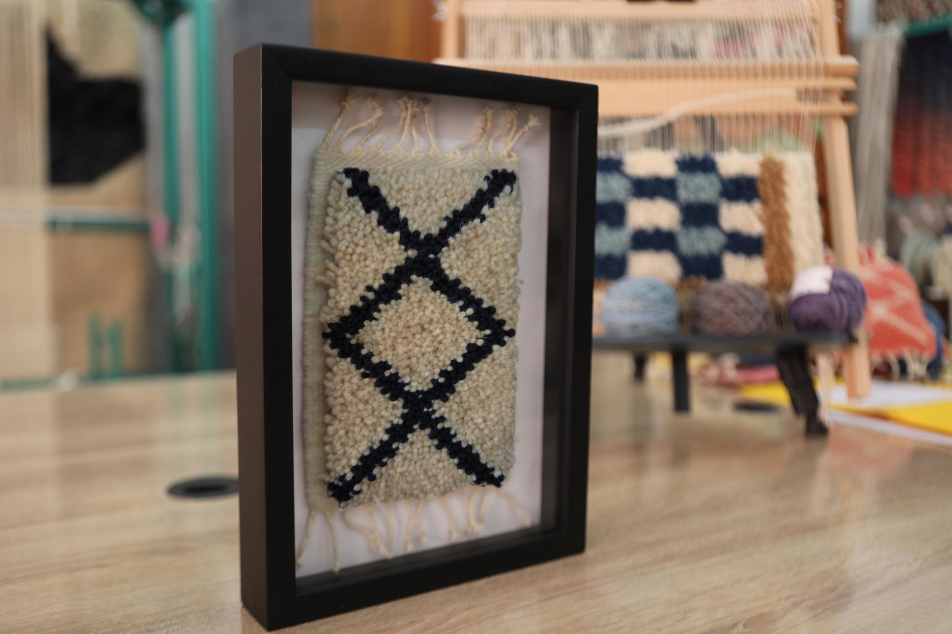 moroccan rug wall art, diamond x pattern rug, hand-knotted wool textile, boho framed rug art, knot by knot moroccan rug, small wall hanging, tribal wool decor, artisan wall art, minimalist textile piece, berber framed rug
