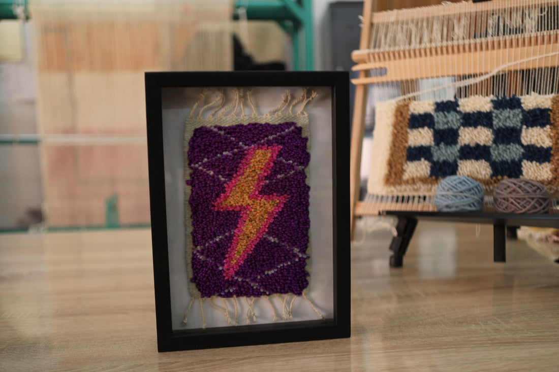 moroccan rug wall art, gradient lightning bolt textile, framed wool mini rug, hand-knotted lightning decor, pink orange yellow bolt art, purple wool tapestry, knot by knot wall hanging, moroccan lightning rug
