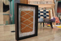 moroccan rug wall art, hand knotted moroccan rug, ochre rug pattern, diamond lattice moroccan weaving, framed textile decor, boho wall hanging, mini moroccan rug art, knot by knot weaving, artisan moroccan wall decor, 25x31 cm
