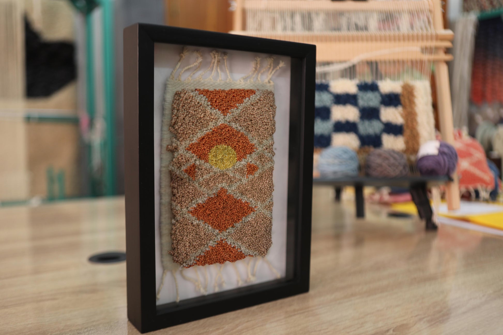 moroccan rug wall art, hand knotted moroccan rug, rising sun rug art, geometric diamond textile, framed boho decor, knot by knot rug, artisan moroccan weaving, 25x31 cm wall hanging, earthy tone rug, desert sun decor
