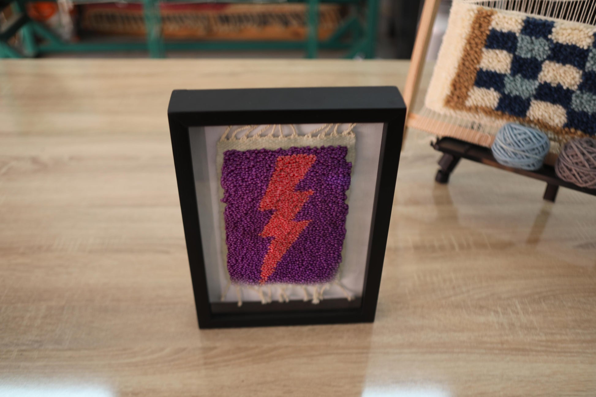 moroccan rug wall art, orange lightning bolt textile, framed wool tapestry, hand-knotted mini rug, purple wall decor, lightning strike rug art, wool knot by knot wall hanging, bold bohemian lightning art
