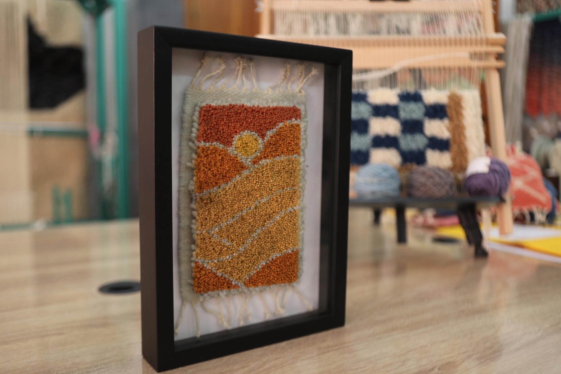 moroccan sunset rug, hand-knotted landscape rug, framed wool rug, boho sunset decor, moroccan rug wall art, knot by knot weaving, desert scene textile, artisan moroccan wall piece, mini sunset tapestry, framed rug 25x31 cm
