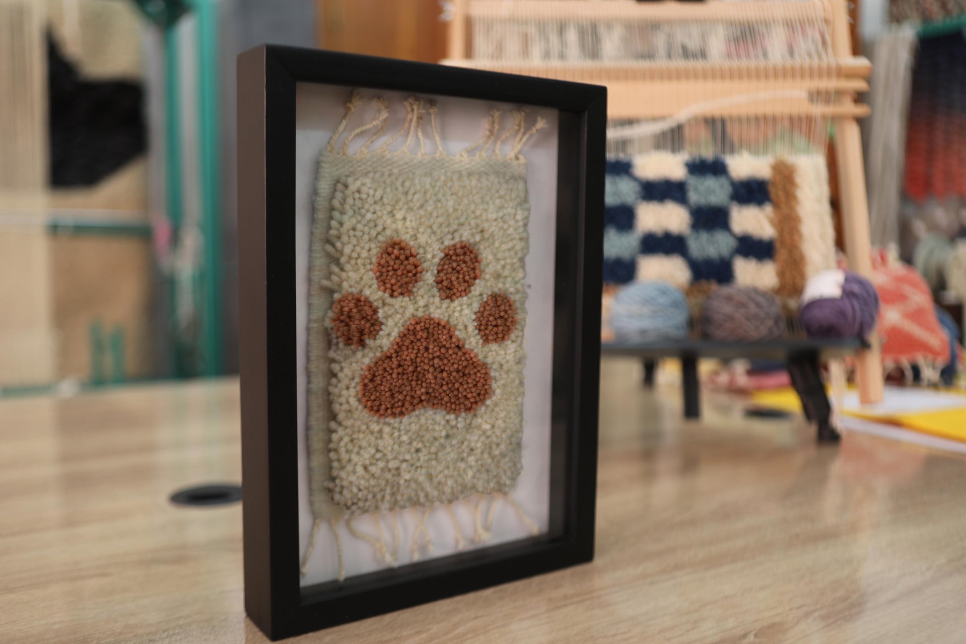 paw print rug, moroccan rug paw design, framed pet wall art, hand-knotted mini rug, dog lover gift, pet tribute decor, small moroccan wall hanging, artisan knotted rug, pet memorial textile, framed wool paw print rug
