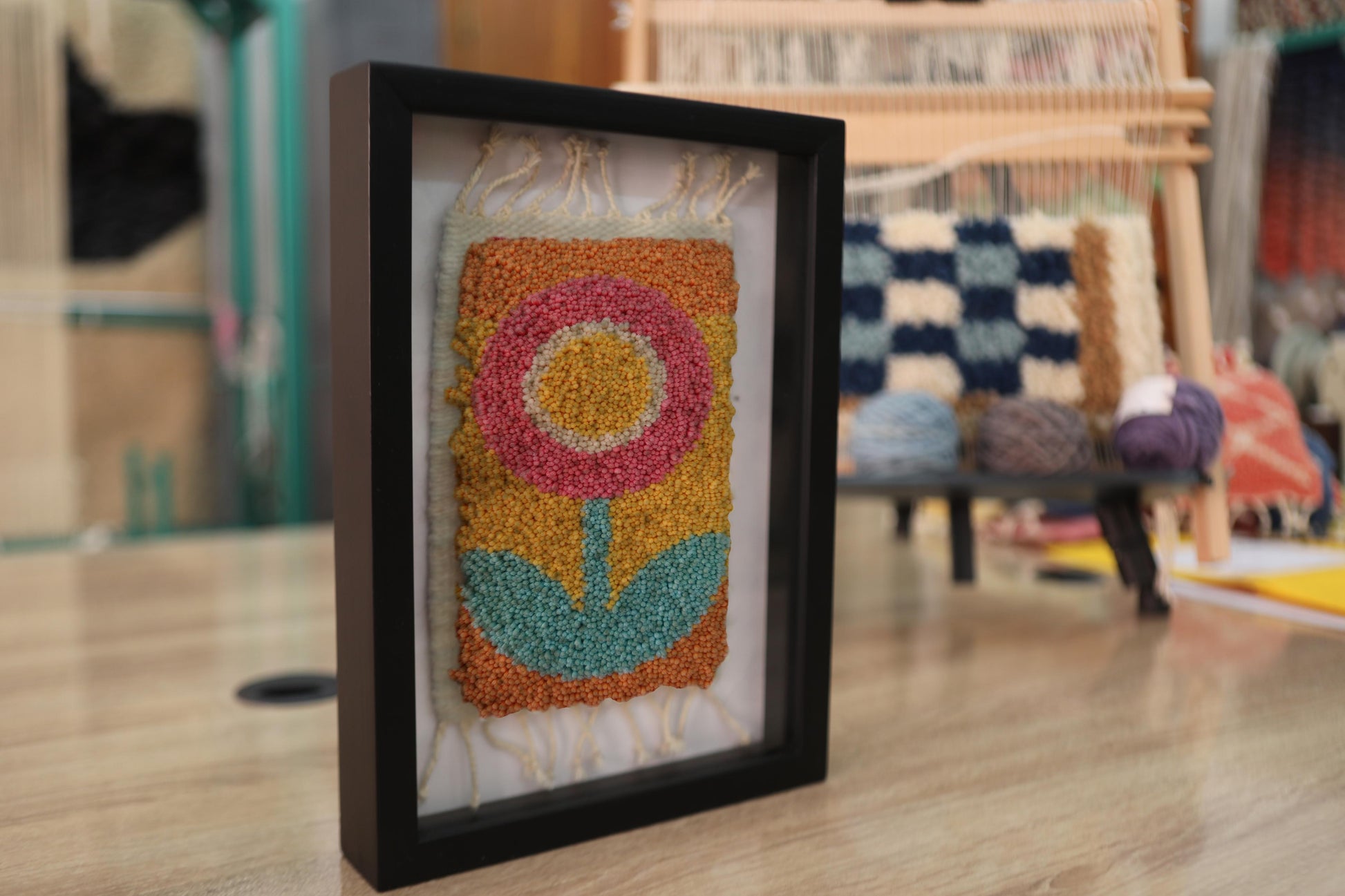 retro flower rug, moroccan rug wall art, hand-knotted wool textile, framed mini rug decor, vintage flower wall hanging, yellow orange pink flower rug, handmade wool tapestry, 25x31 cm rug art, knot by knot rug, bohemian floral decor
