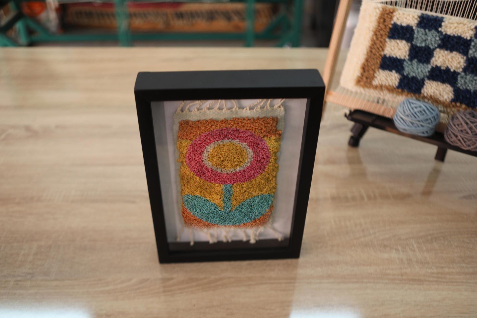 retro flower rug, moroccan rug wall art, hand-knotted wool textile, framed mini rug decor, vintage flower wall hanging, yellow orange pink flower rug, handmade wool tapestry, 25x31 cm rug art, knot by knot rug, bohemian floral decor
