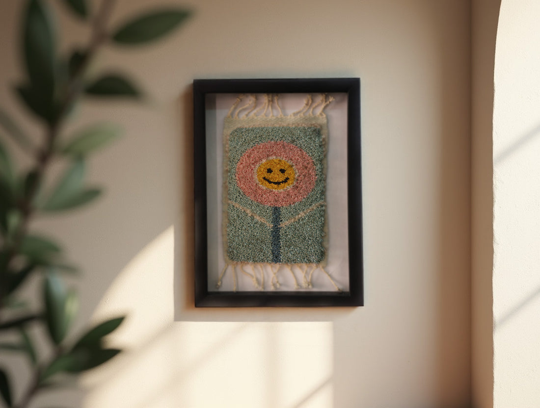 smiling flower rug, moroccan rug wall art, hand-knotted mini wool tapestry, happy flower textile decor, boho wall hanging, pink floral face rug, knot by knot moroccan rug, wool flower wall art, 25x31 cm framed rug, joyful flower textile art
