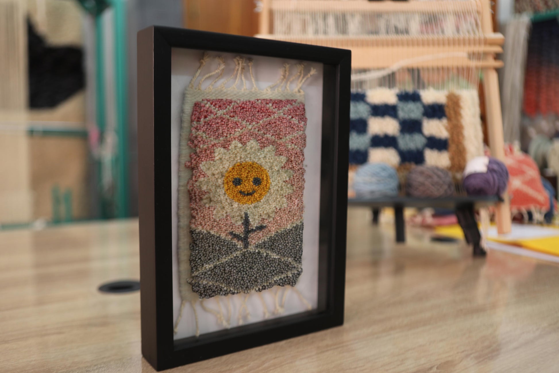 sunflower mini rug, hand-knotted moroccan rug, smiling flower wall art, moroccan wall decor, sunset textile art, mini wool rug, framed rug artwork, boho home decor, moroccan rug flower, knot by knot weaving, 25x31 cm handmade rug
