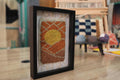 sun moroccan rug wall art, hand-knotted wool tapestry, framed mini rug, moroccan sun wall decor, boho wool art, desert sunset textile, artisan moroccan weaving, knot by knot rug, 25x31 cm mini wall rug, sunrise decor
