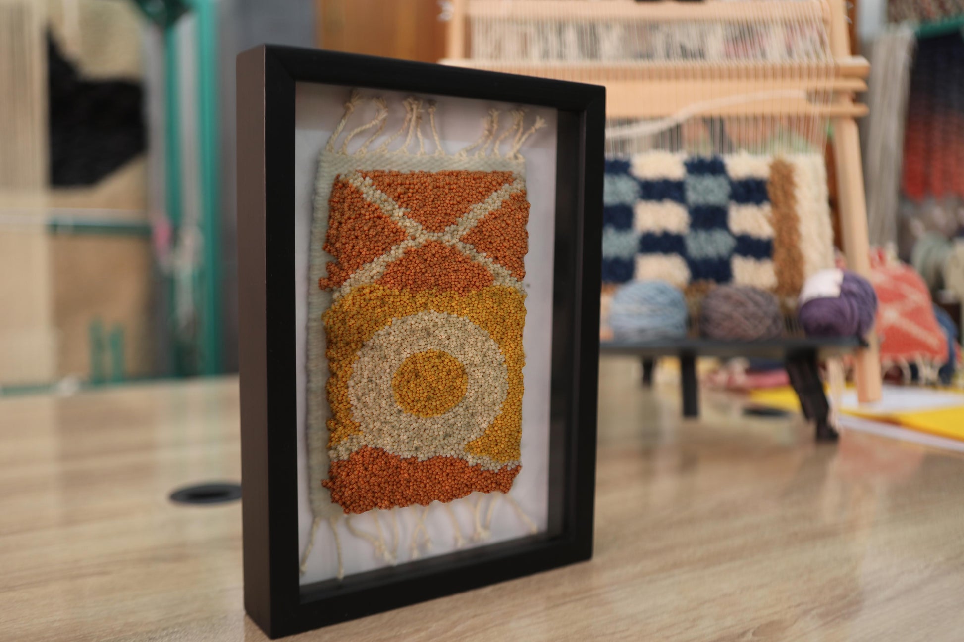 sun motif moroccan rug, framed moroccan wall art, hand-knotted wool rug, small moroccan rug artwork, knot by knot rug, bohemian wall decor, moroccan textile art, orange and yellow mini rug, 25x31 cm rug wall hanging, artisan moroccan wool tapestry
